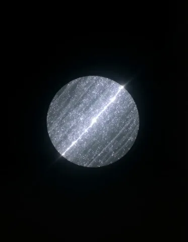 Silver orbit — A small glittering silver planet crossed by a bright diagonal line on pure black, minimal cosmic composition.